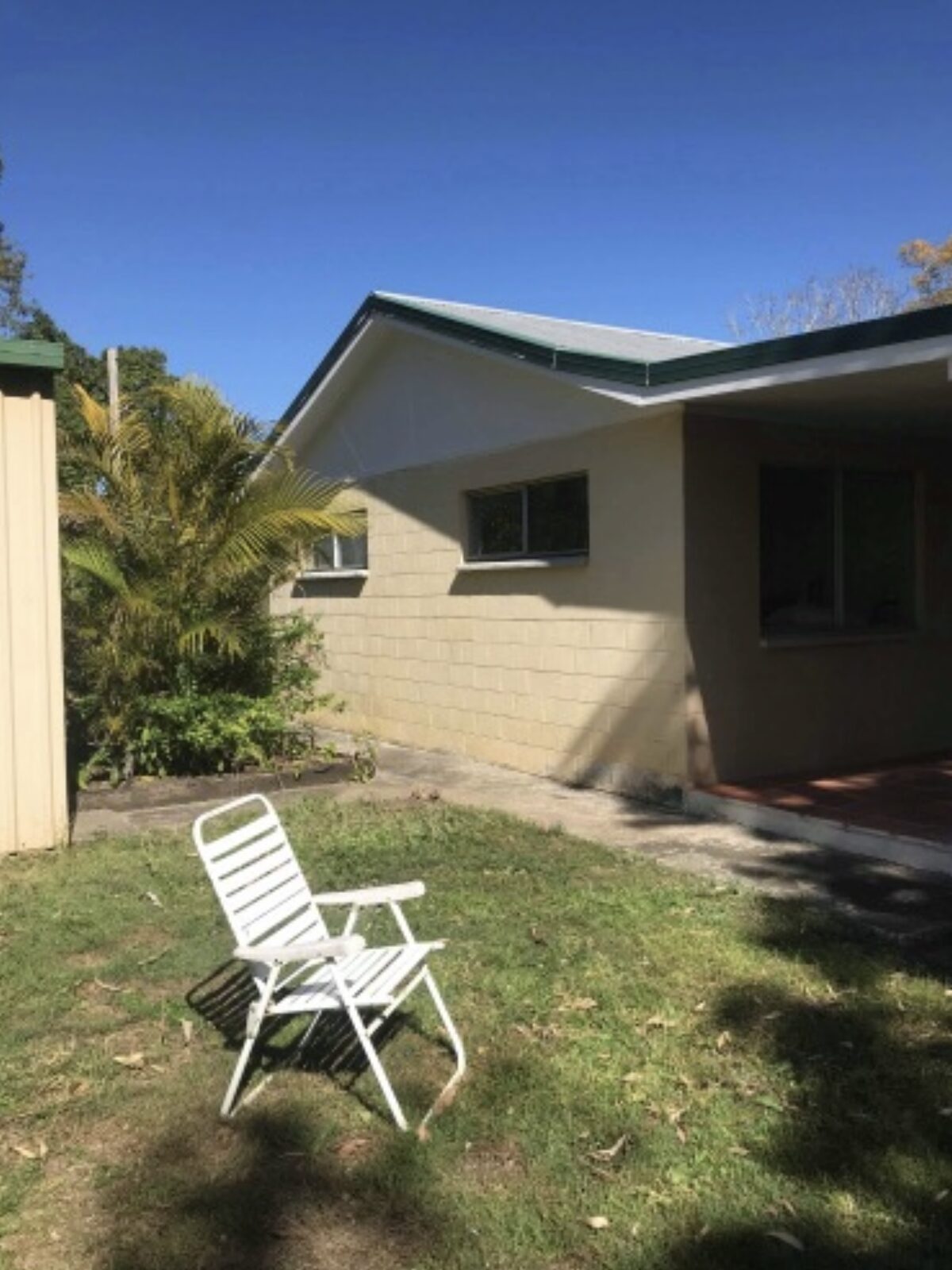 Same home — side elevation and entry — before render